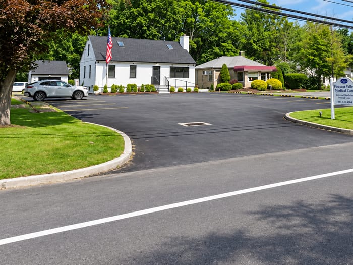 The white office building and parking lot on Route 44